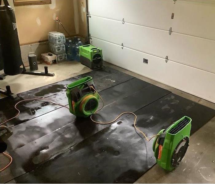 Garage with SERVPRO drying equipment on mats 