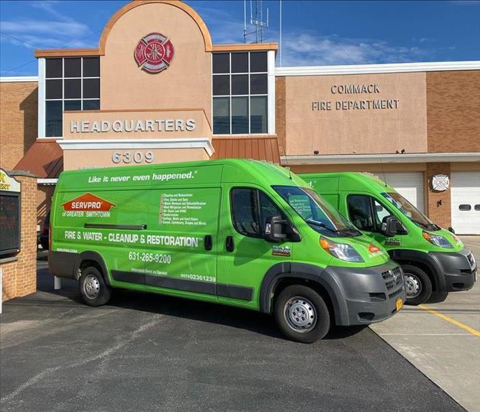 SERVPRO green service vans parked in front of a fire department building